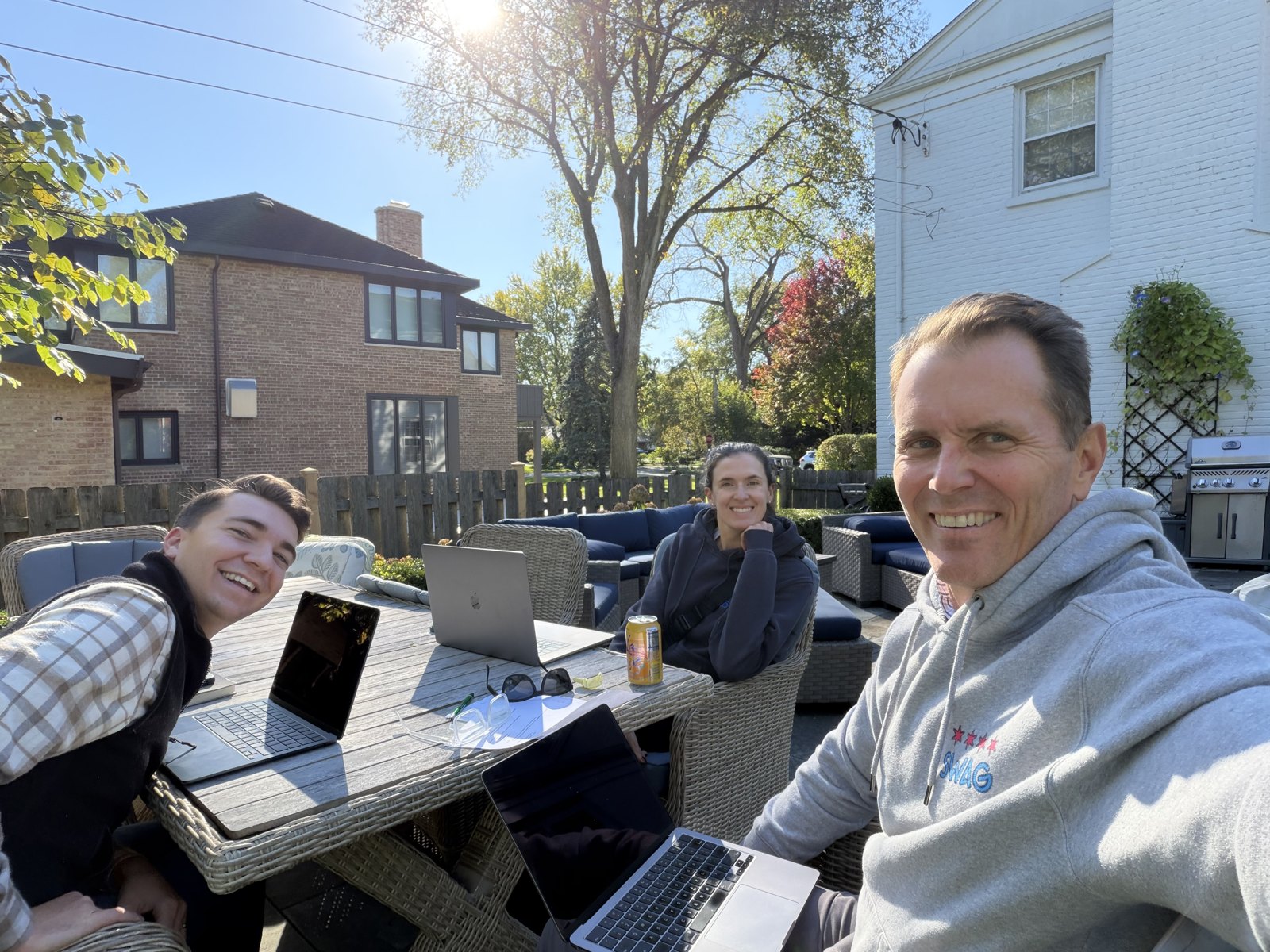 Three people working on a patio at 2:42